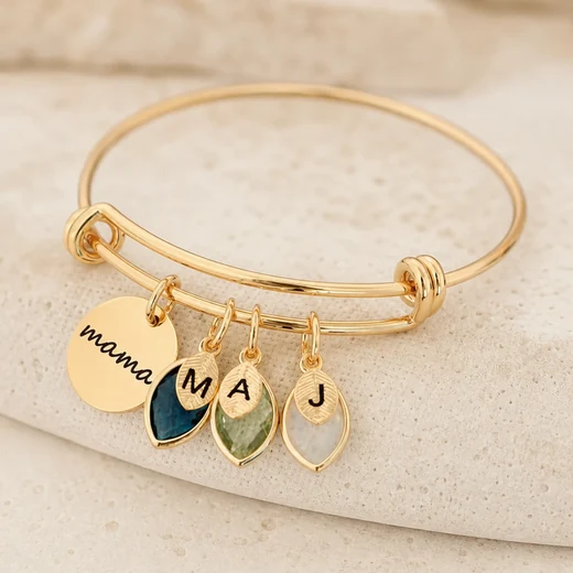 Gold tone adjustable bangle with engraved family charms and colorful birthstones
