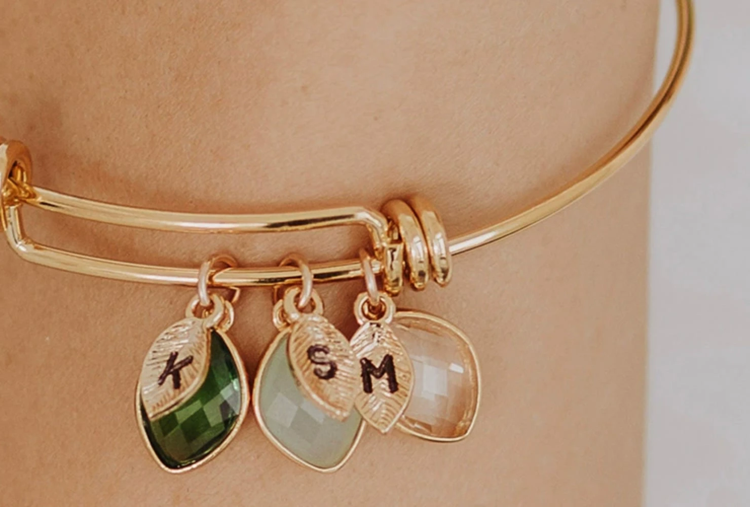 Engraved family birthstone bangle worn on the wrist