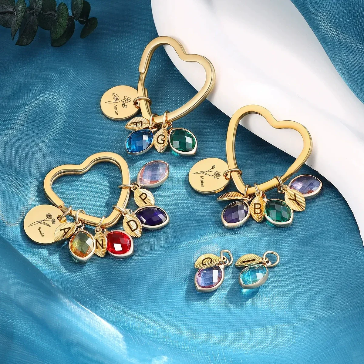 Family Branch design shown as a bangle, round keyring, and heart keyring