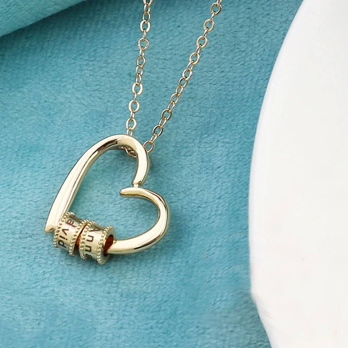 Gathered Hearts Name Necklace showing individual engraved name beads gathered on the open heart