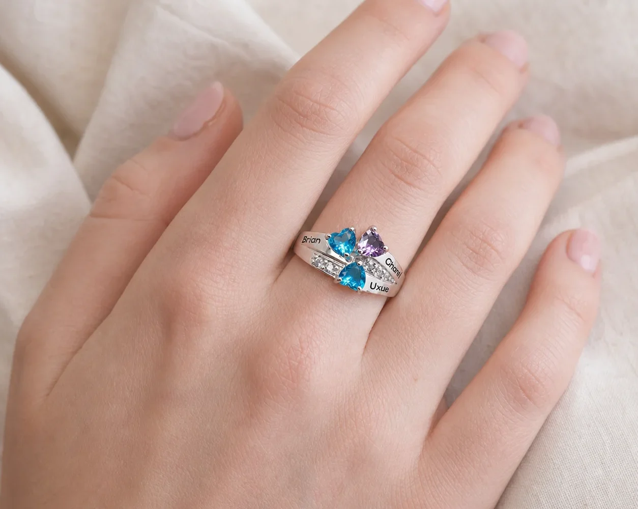 Personalized family birthstone ring worn on the hand at everyday scale