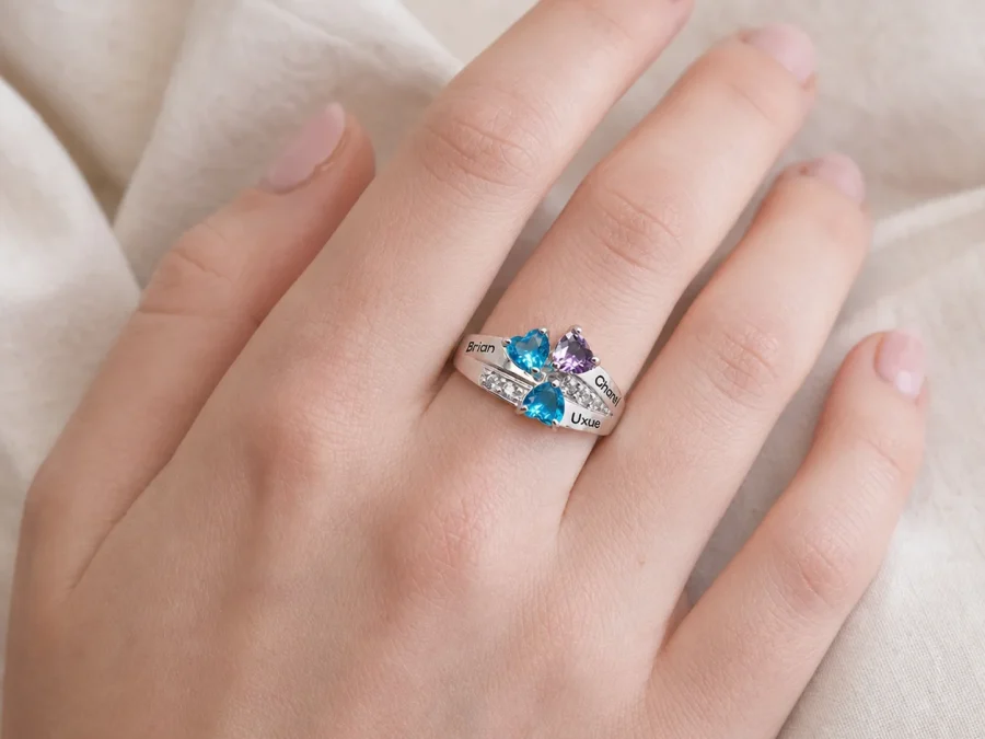 Personalized family birthstone ring worn on the hand at everyday scale
