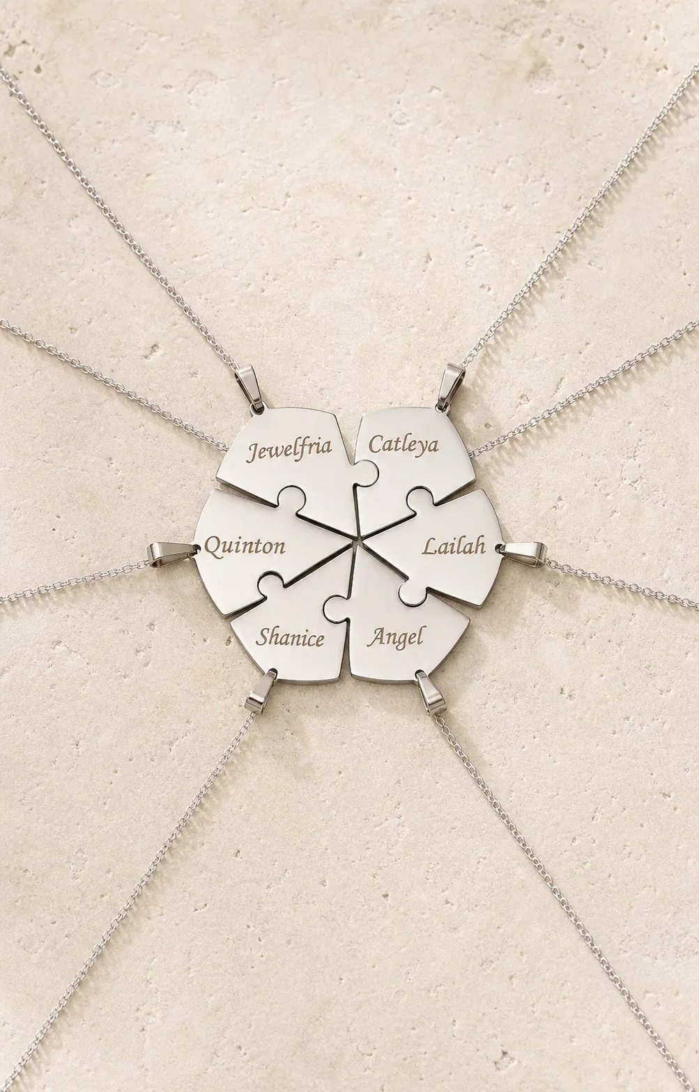 Engraved heart puzzle necklaces arranged as a coordinated family set